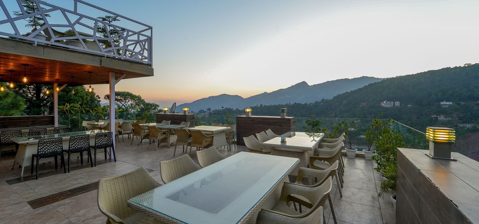The open dining area set up with chairs and tables on the terrace at DLS Whispering Winds